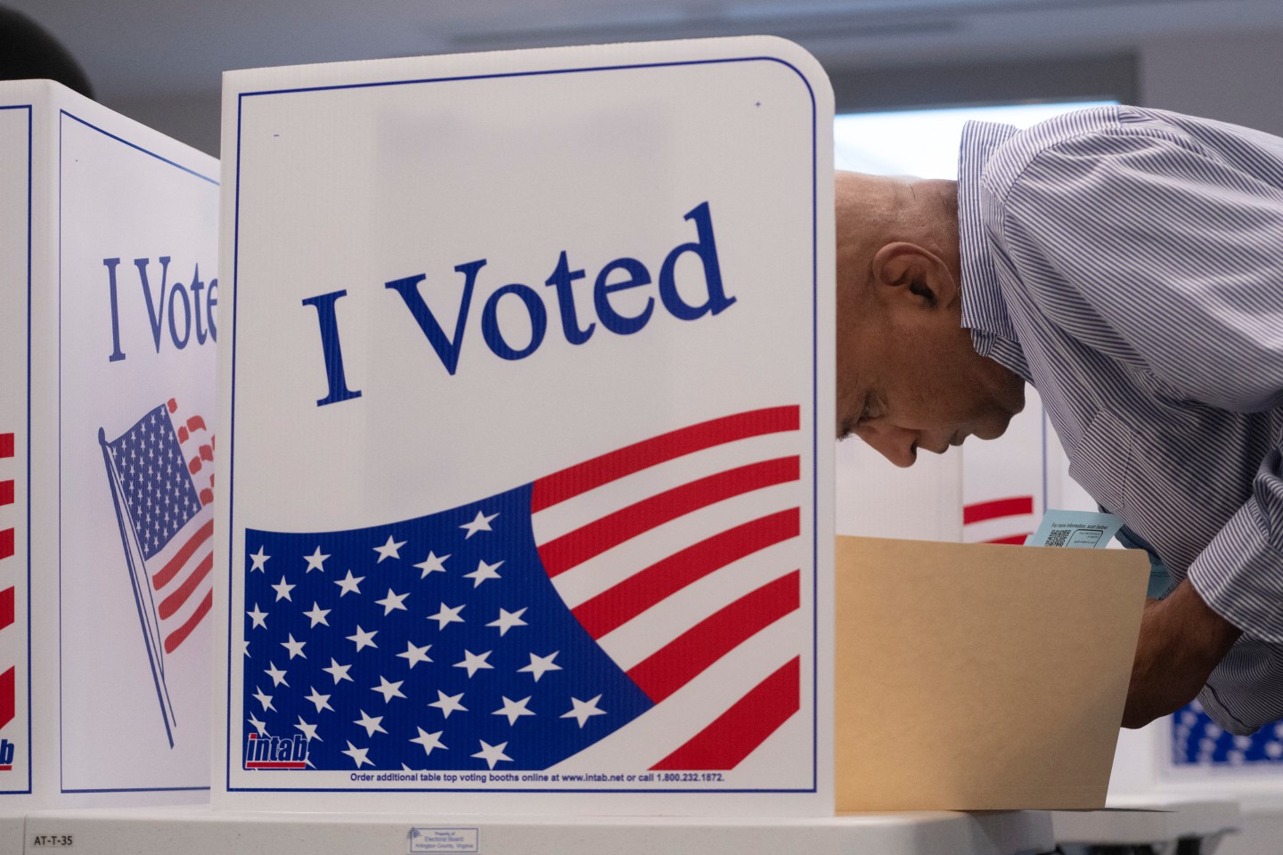 An early voter works on his ballot at a polling station in Arlington, Virginia, on Sep. 20.