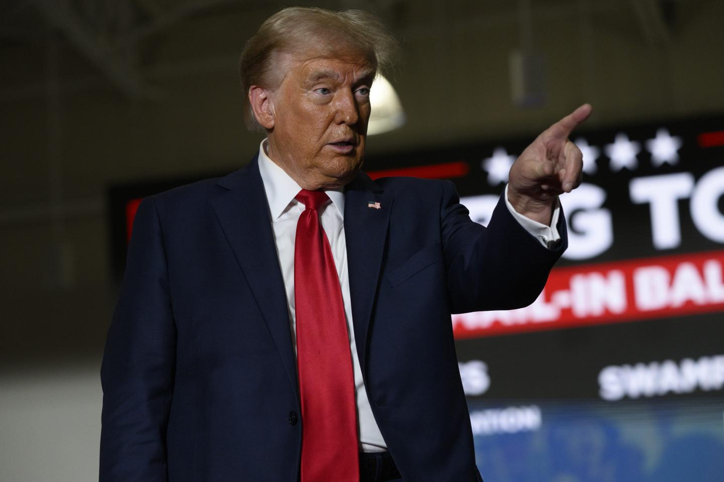 Former President Trump points during a campaign rally