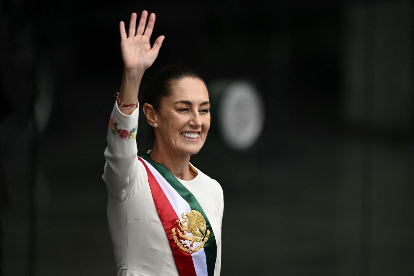 Mexican President Claudia Sheinbaum waves