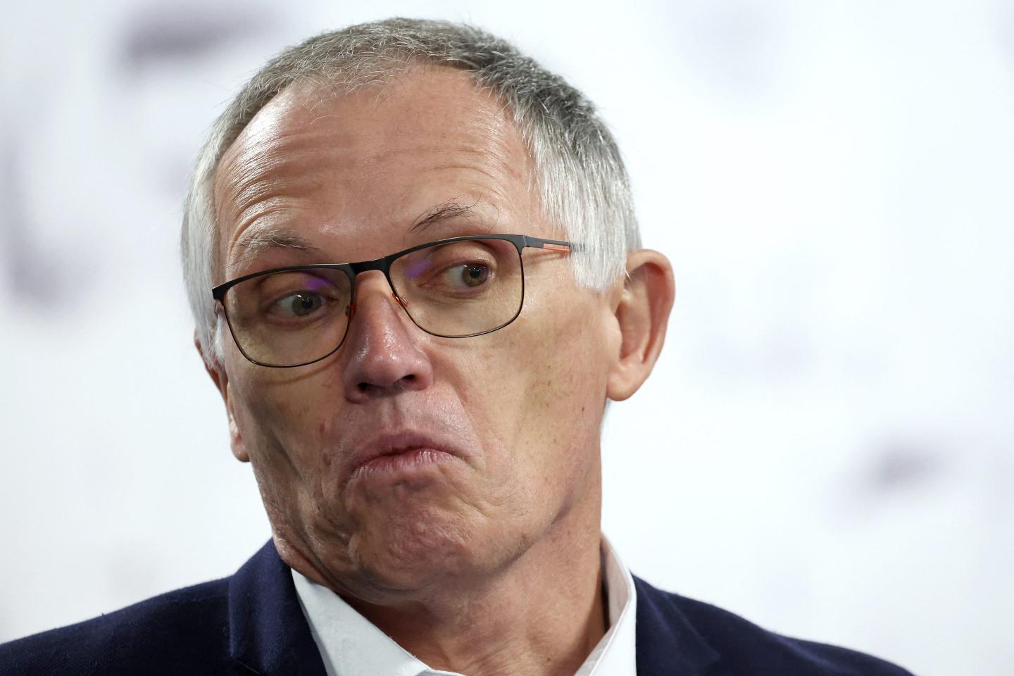 Stellantis CEO Carlos Tavares (C) answers journalists' questions after attending a visit of the production line of the new Peugeot e-3008 and e-5008 electric car at the Stellantis car factory in Sochaux, eastern France on October 3, 2024.