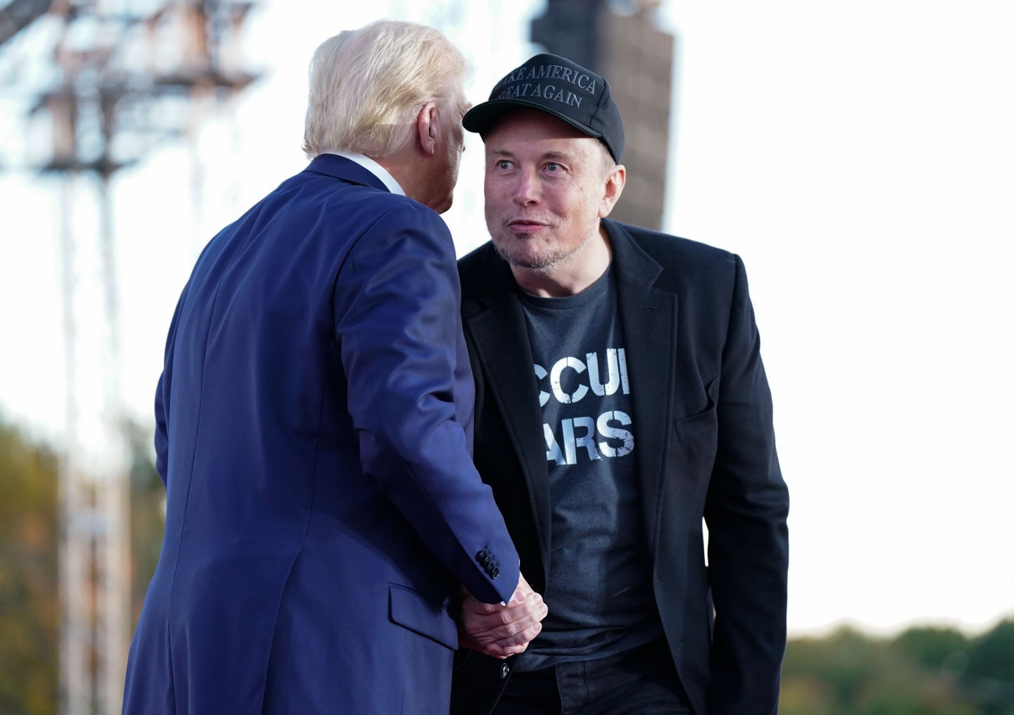 Tesla and SpaceX CEO Elon Musk speaks with former President Donald Trump during a campaign event on Oct. 5 in Butler, Pa.
