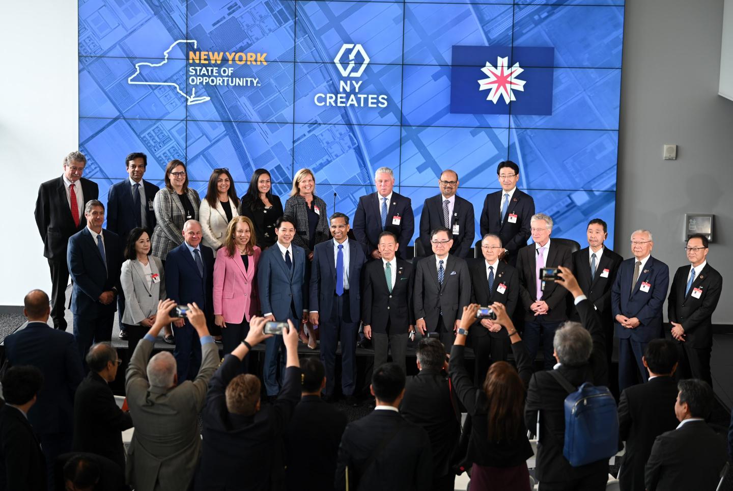 Leaders stand together for a picture at an event at the Albany NanoTech Complex in New York