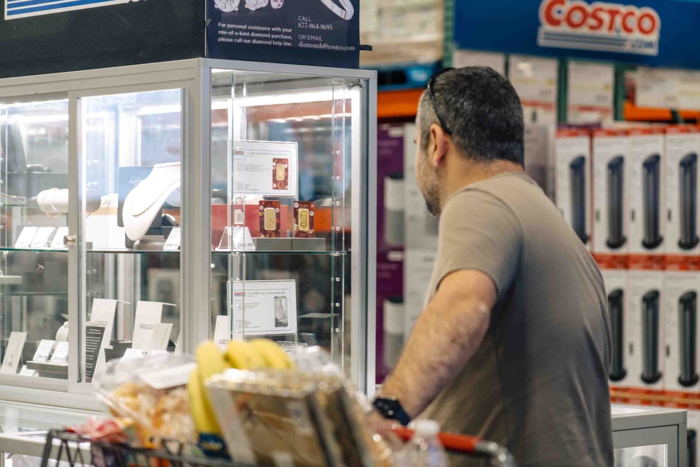 A shopper looks at gold bars displayed for sale at a Costco