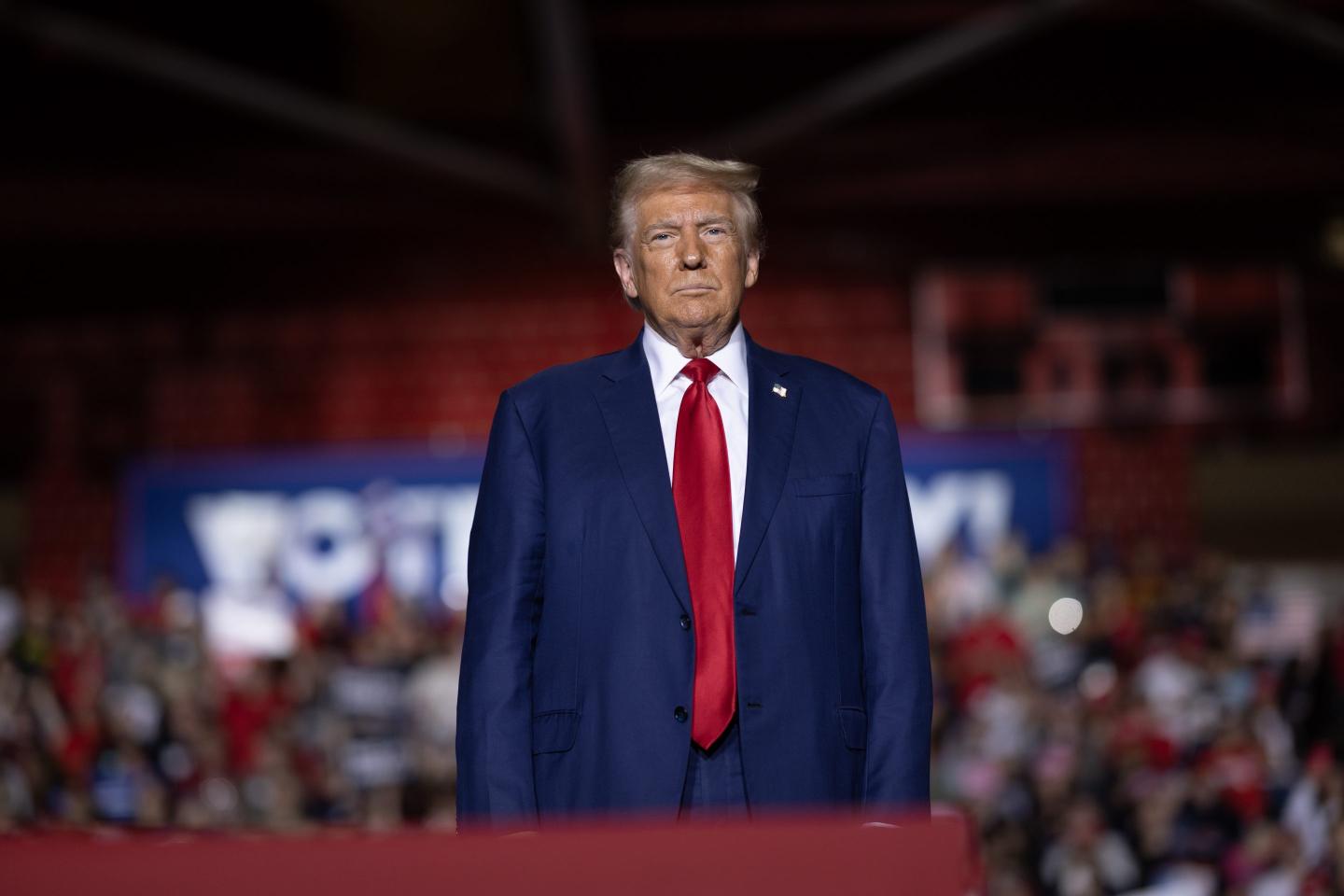 Donald Trump stands at podium
