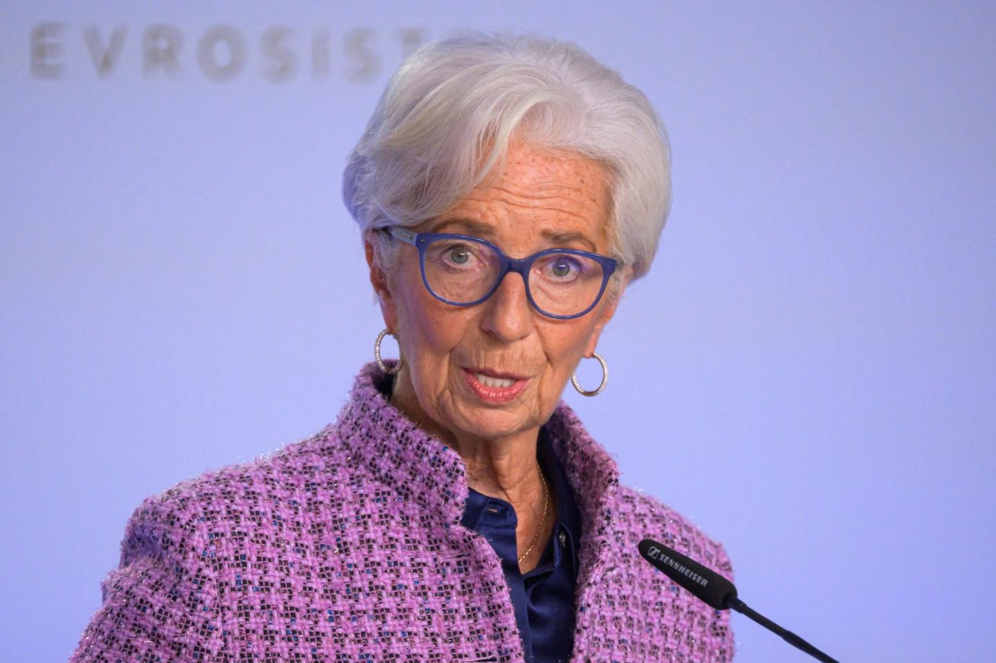 President of the European Central Bank Christine Lagarde stands in front of a microphone
