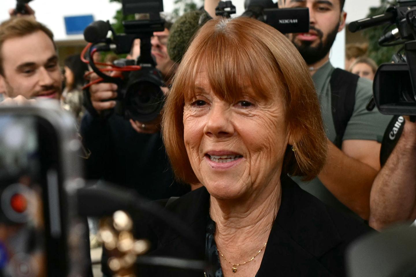senior woman speaking to press with cameras