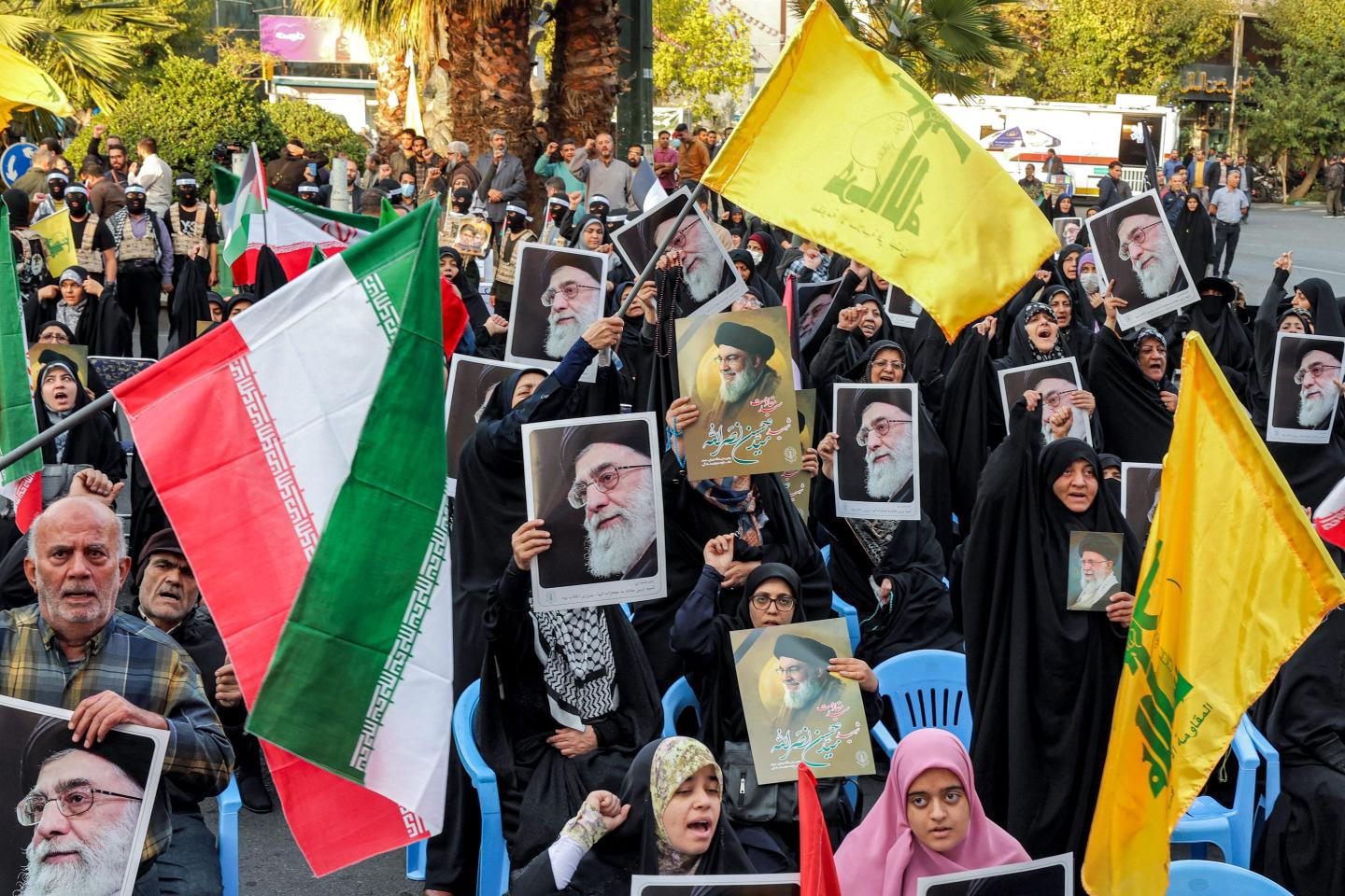 Demonstrators wave flags of Iran, Lebanese Hezbollah, and pictures of Iran's Supreme Leader Ayatollah Ali Khamenei and the slain Hezbollah Leader Hassan Nasrallah during an anti-Israel rally in Tehran on Oct. 24, 2024. 