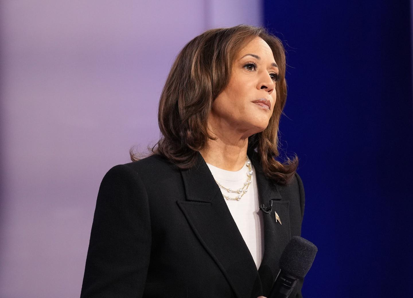 Kamala Harris holds microphone