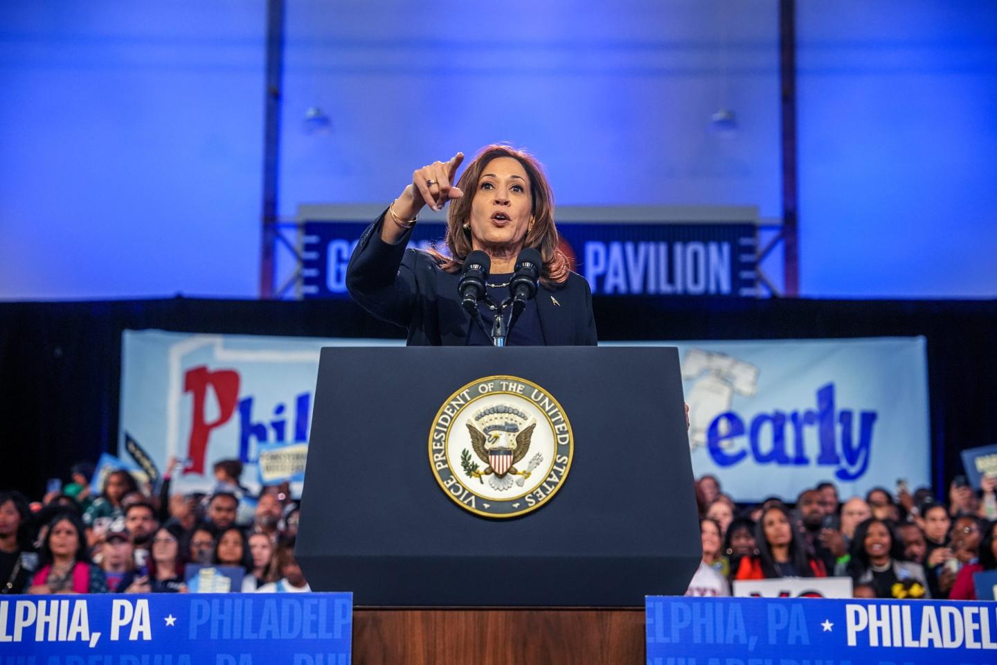 Kamala Harris points at the crowd as she speaks at a podium in Philadelphia.
