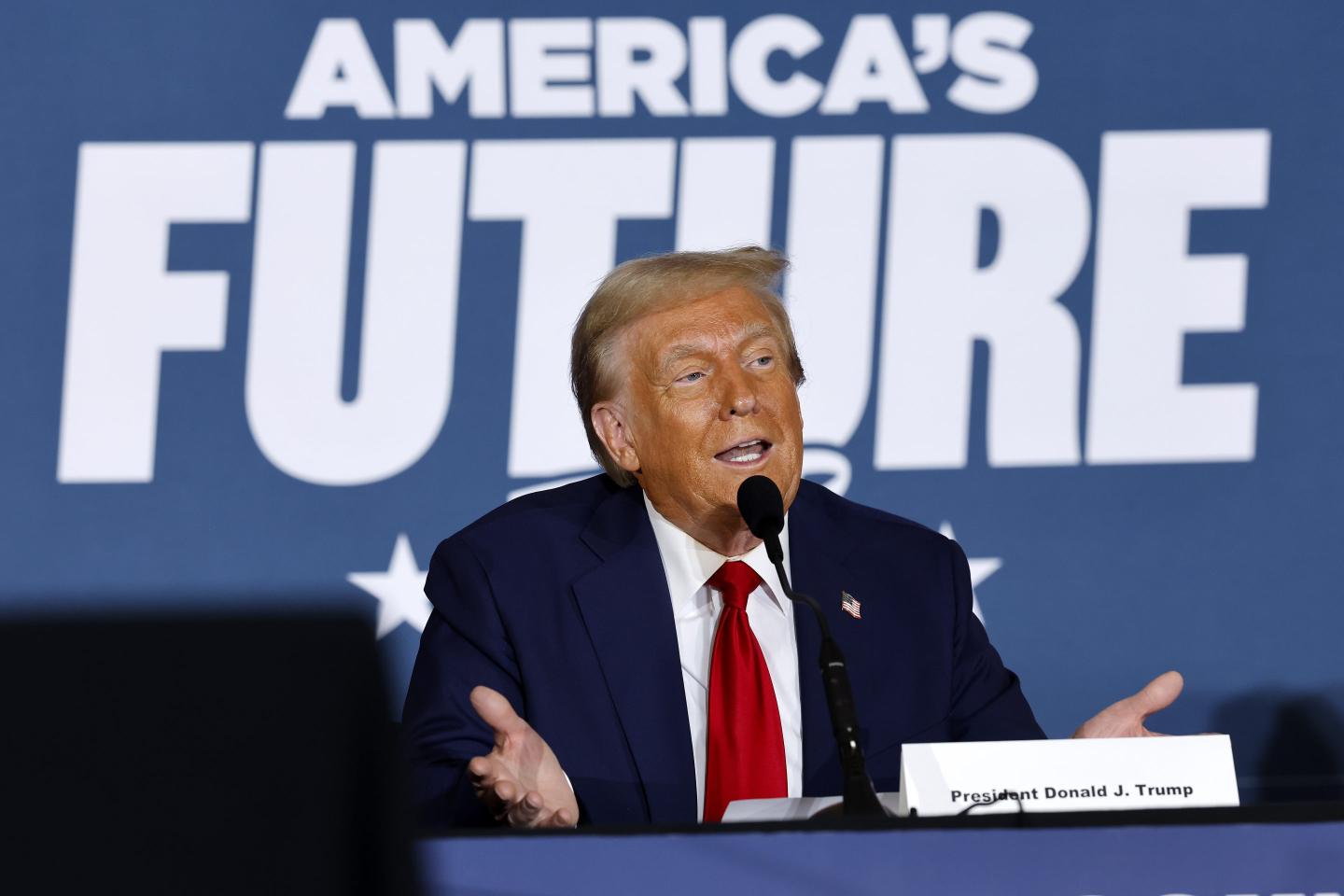 donald trump speaking into a microphone