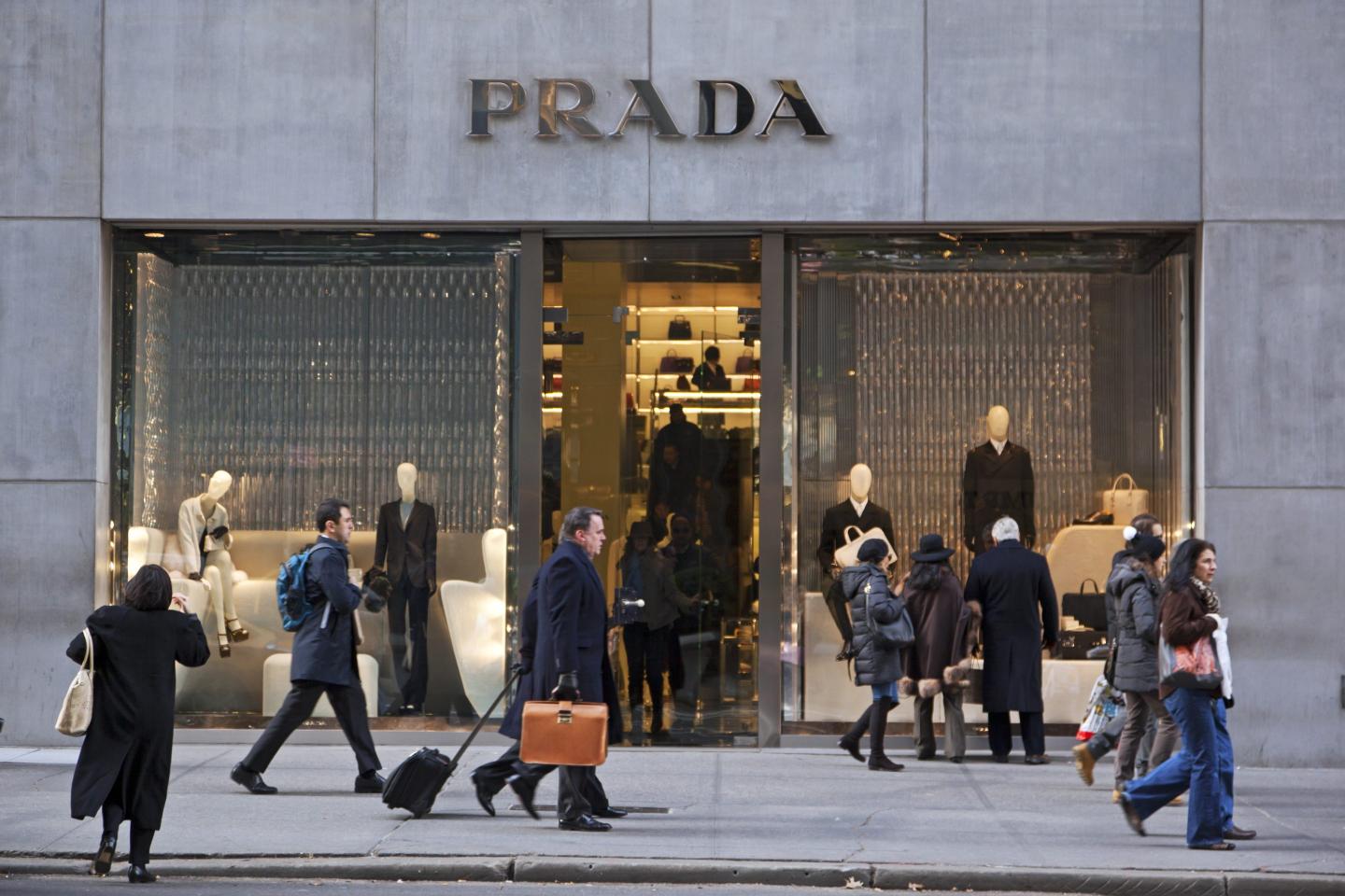 "New York City, USA - December 6, 2012: The Prada store on Fifth Avenue in Midtown Manhattan. Prada is a well known designer of men's and women's clothing and accessories. Many people can be seen on the sidewalk."
