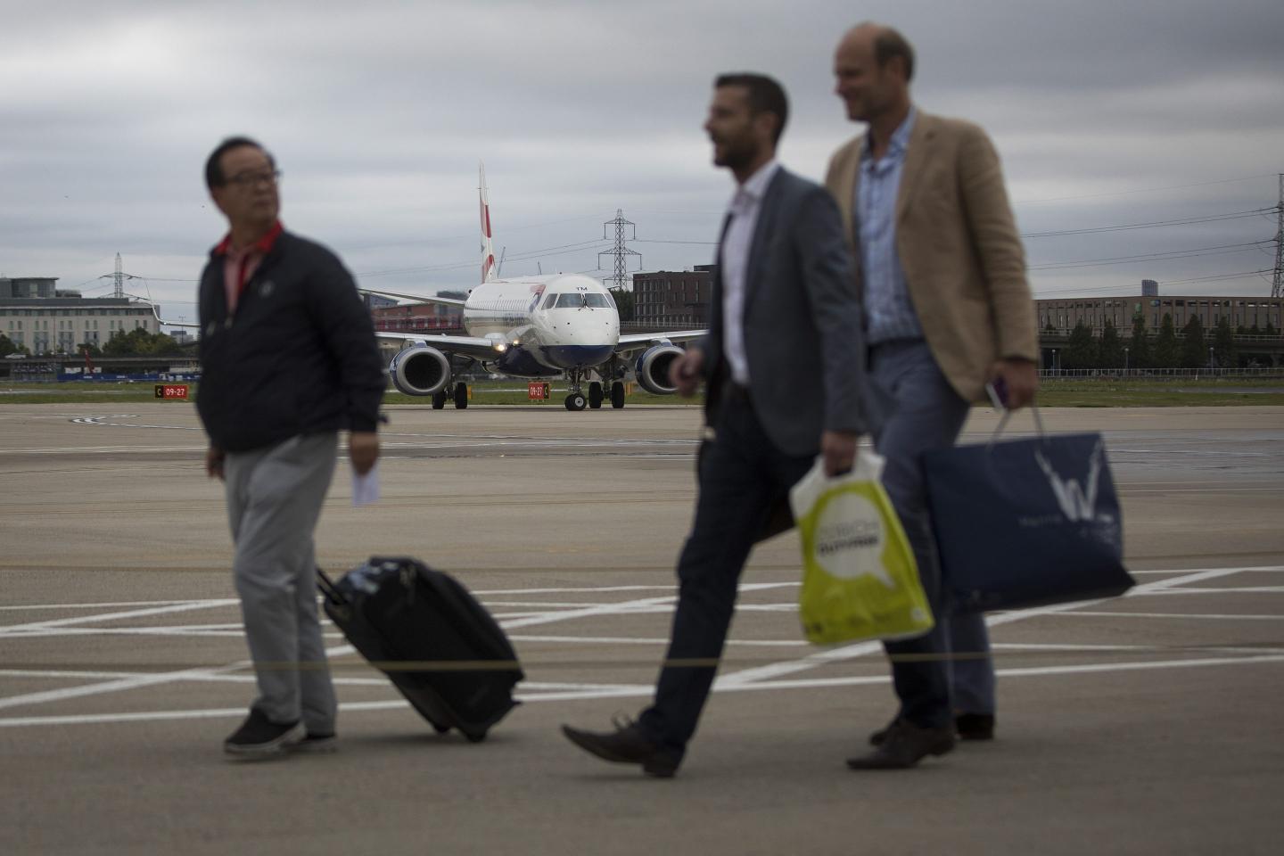 passengers getting off an airplane