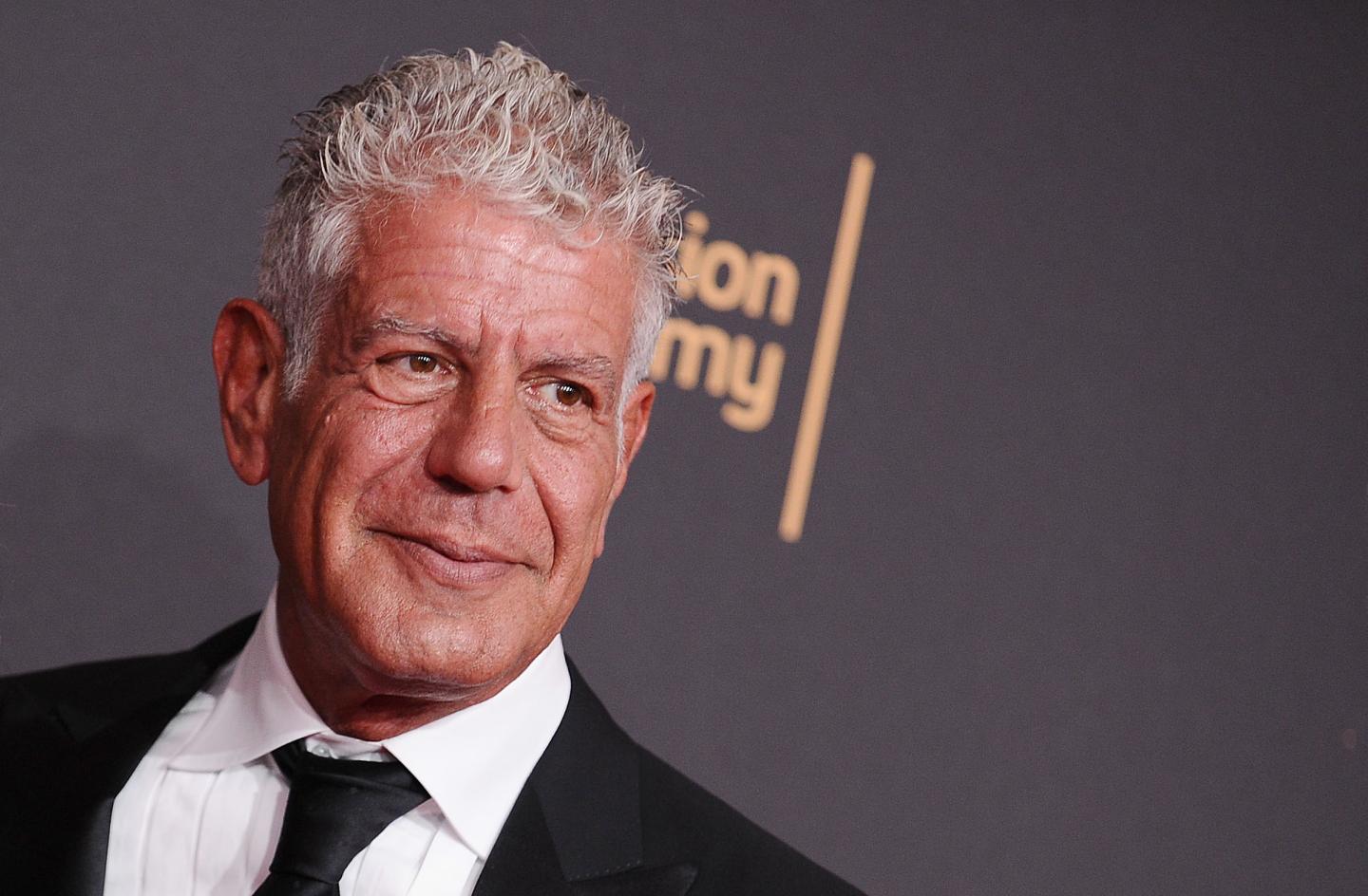 Anthony Bourdain in 2017 seen up close at a red carpet event. He is wearing a formal suit and tie.