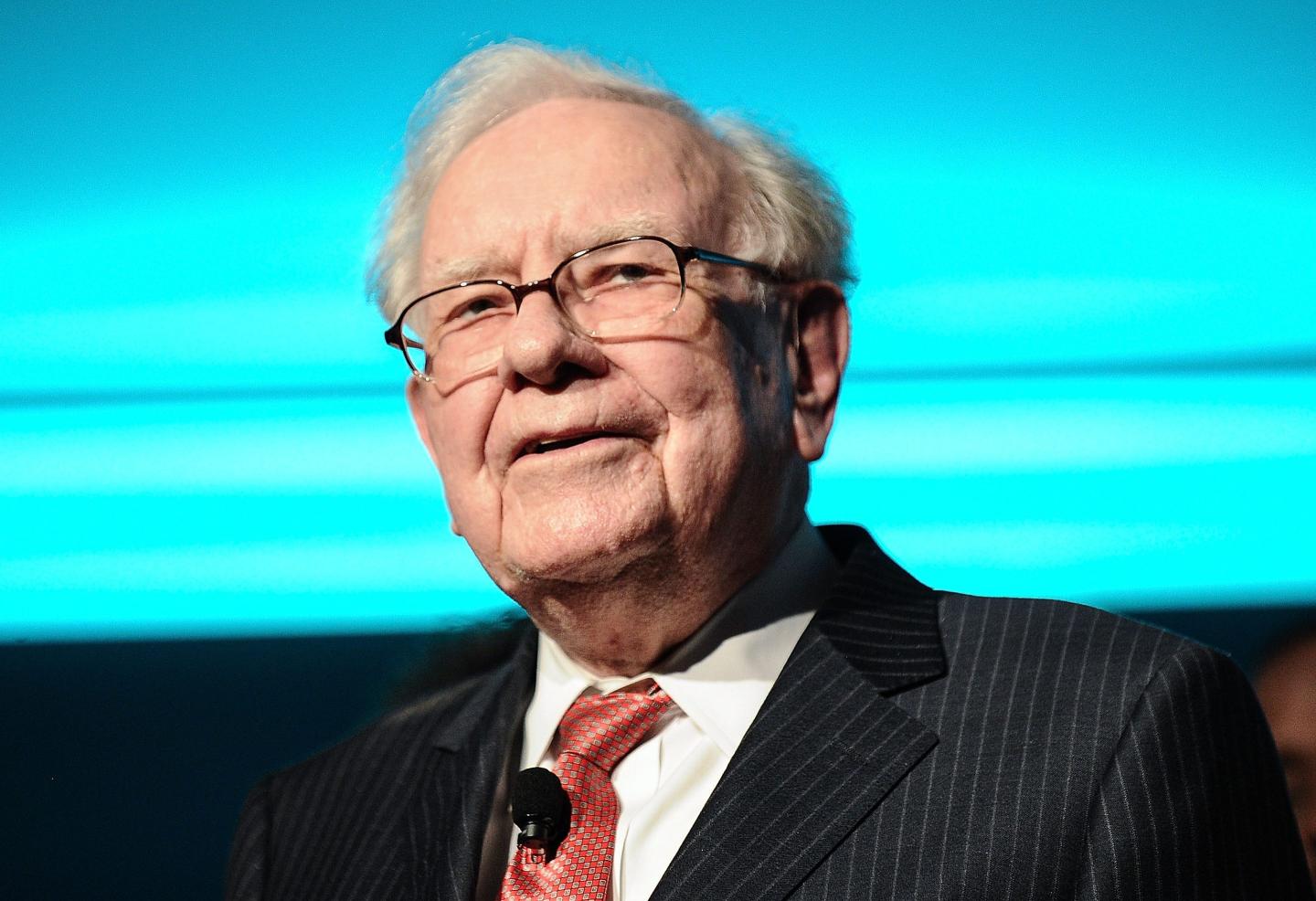 Warren Buffett is seen in glasses and a suit.
