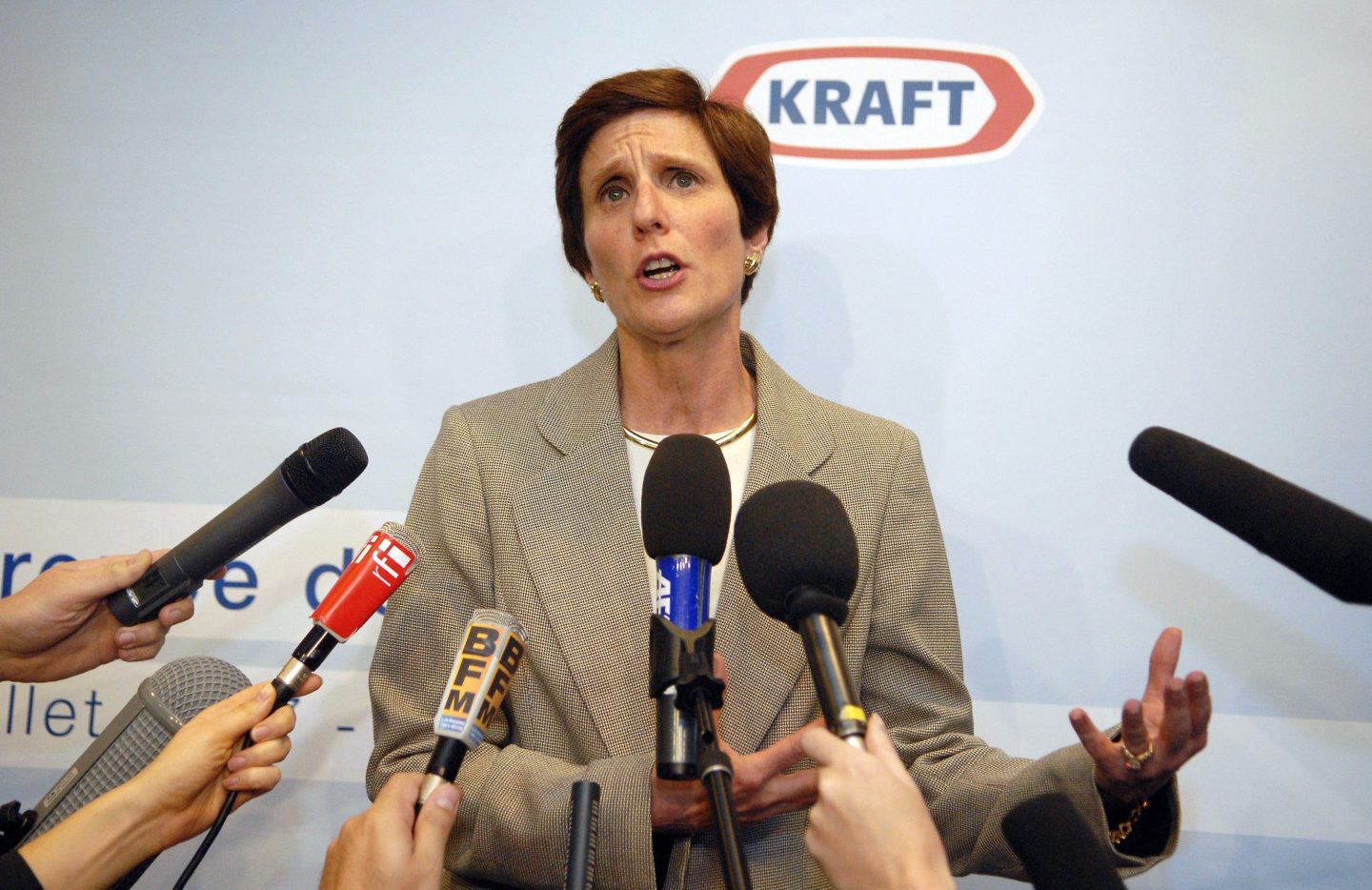 Former Kraft Foods CEO Irene Rosenfeld stands in front of microphones at a news conference.