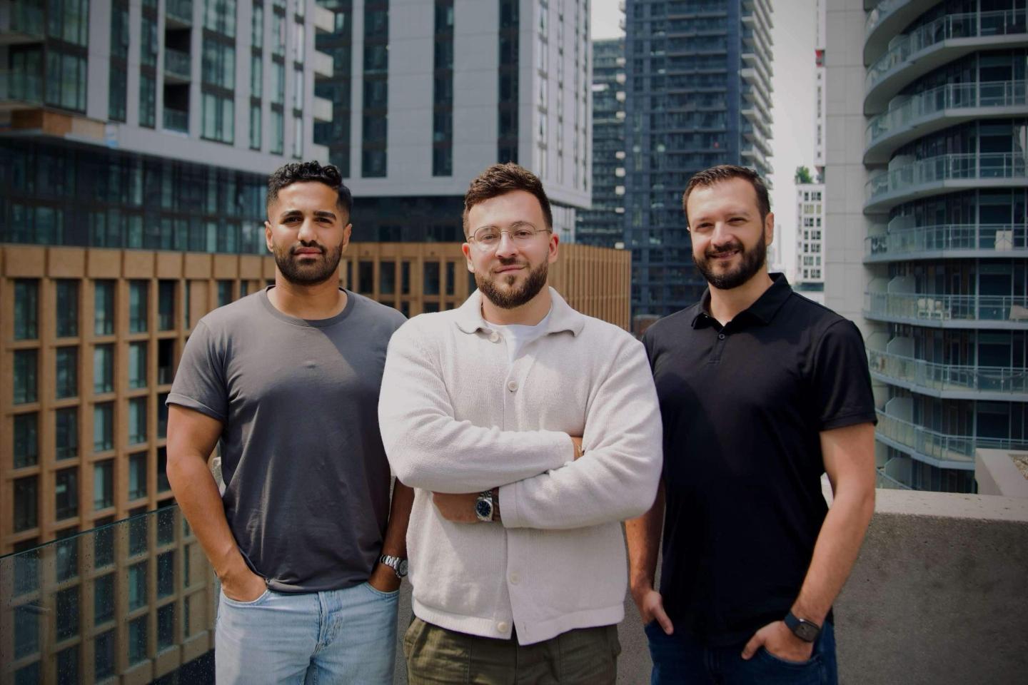 three young men standing in a row posing for a portrait