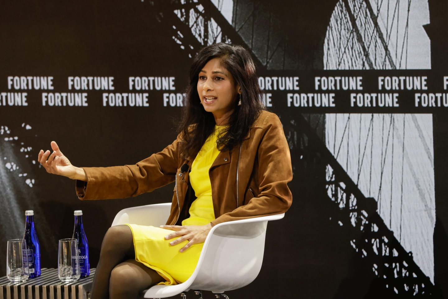 businesswoman seated on a conference stage