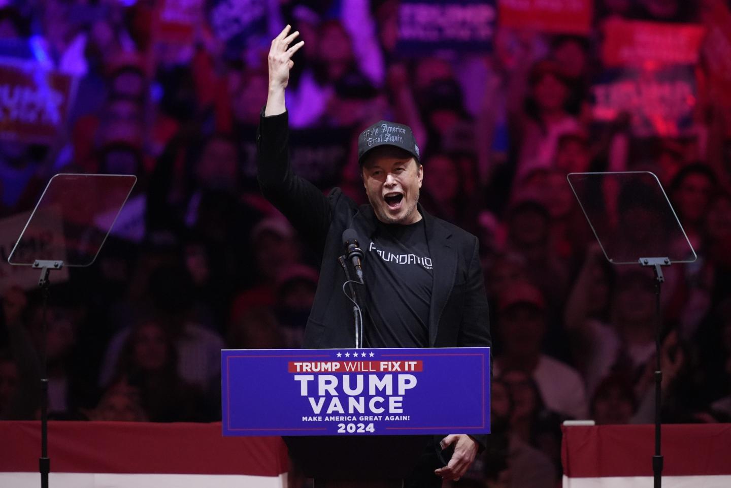 Elon Musk is seen at a Trump podium