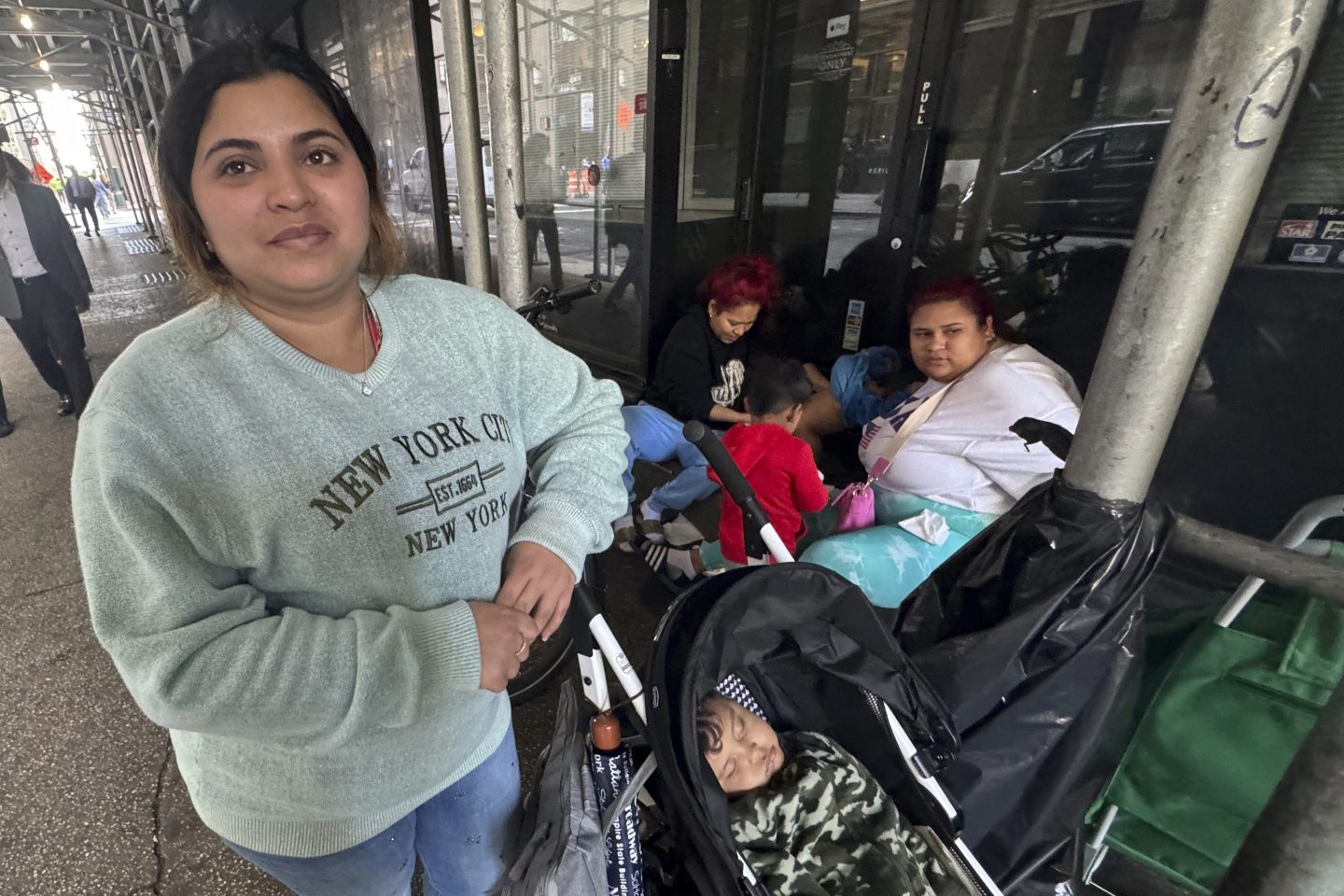 Maribel Hidalgo, 23, of Caracas, Venezuela, stands for a portrait with her son, Daniel, 2, outside a shelter for immigrants in New York, on Nov. 6, 2024.
