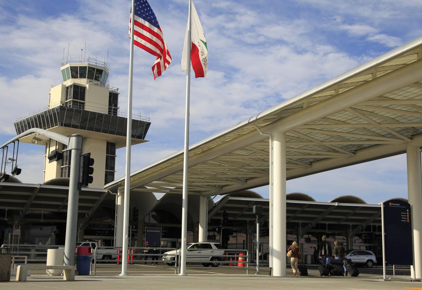 Travelers prepare to enter Oakland International airport on Nov. 26, 2013, in Oakland, Calif.