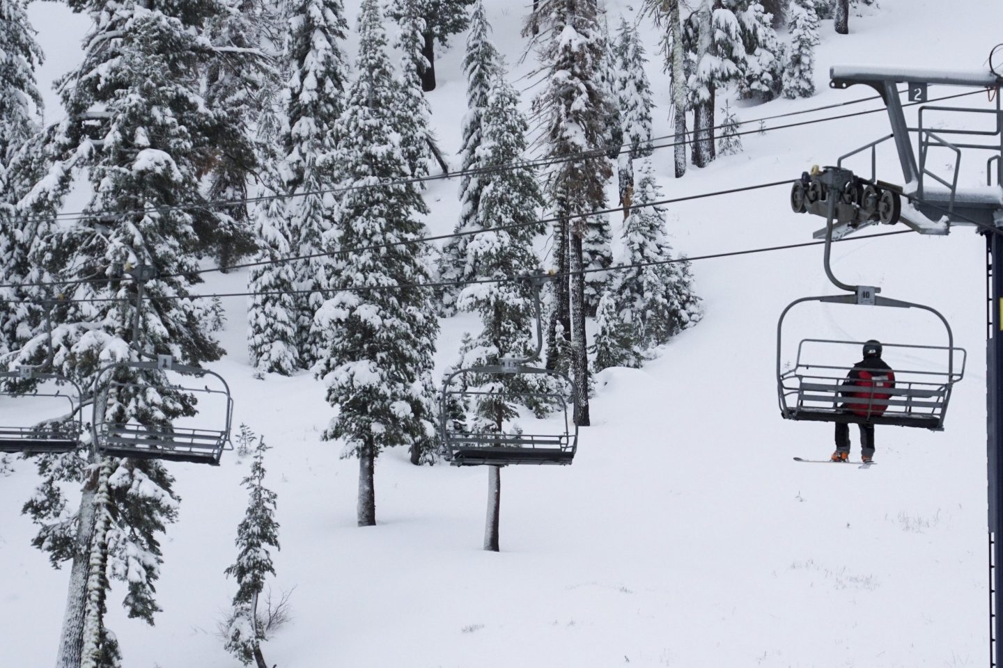 A lone skier rides on a lift on Nov. 21, 2024, at Sugar Bowl Ski Resort in Norden, Calif.