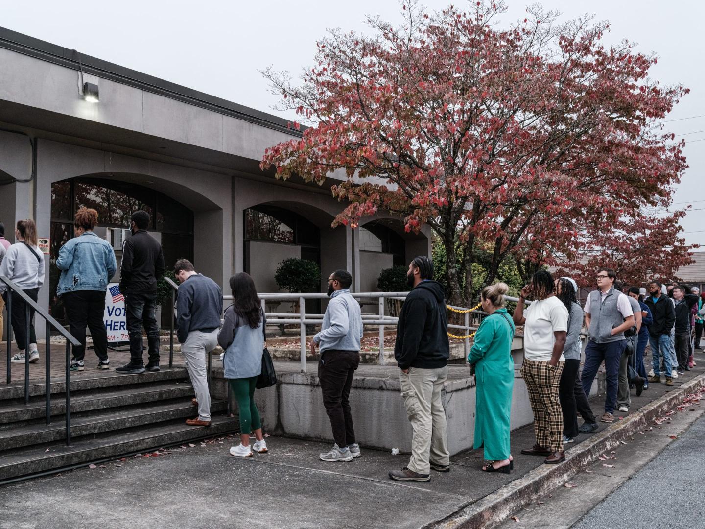 People wait in line to vote