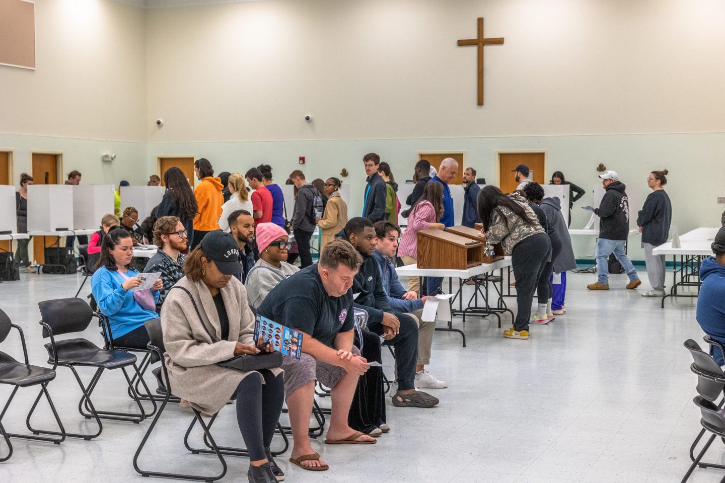 People vote as others wait in line at a polling station at Greater Mount Moriah Baptist Church in Charlotte, North Carolina, located within Mecklenburg County, on November 5, 2024.
