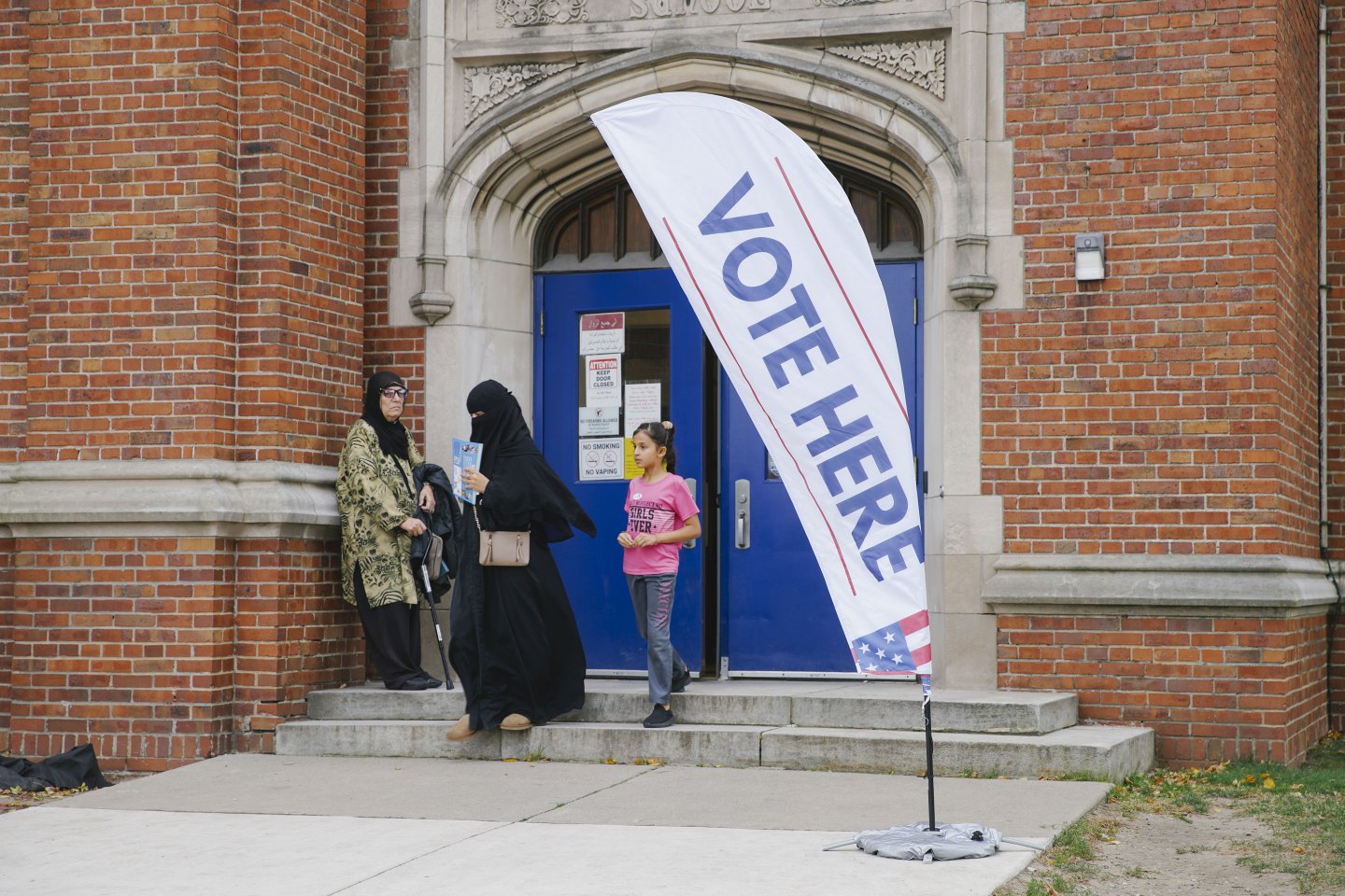 Citizens arrive at the polling center to cast their votes.