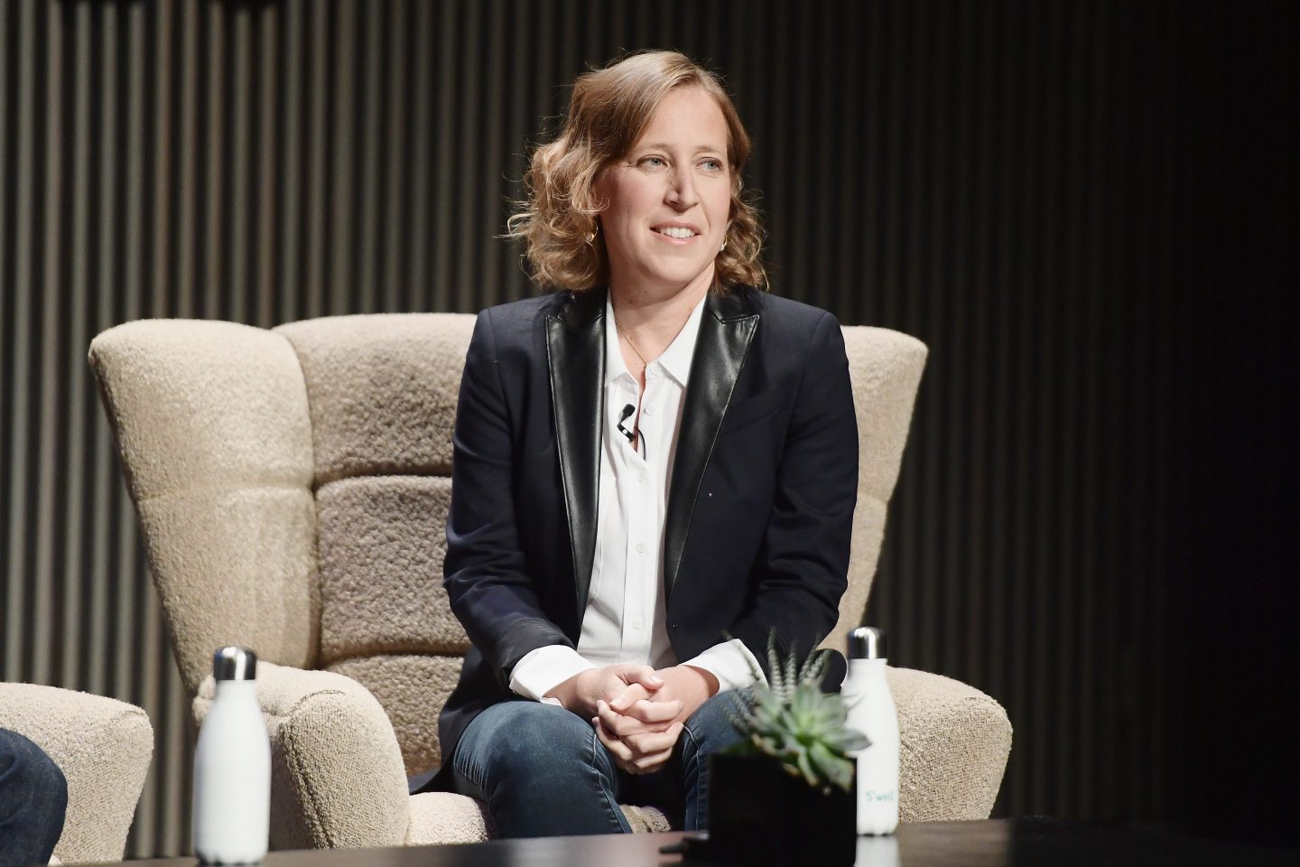 woman in professional attire, Susan Wojcicki, speaks onstage