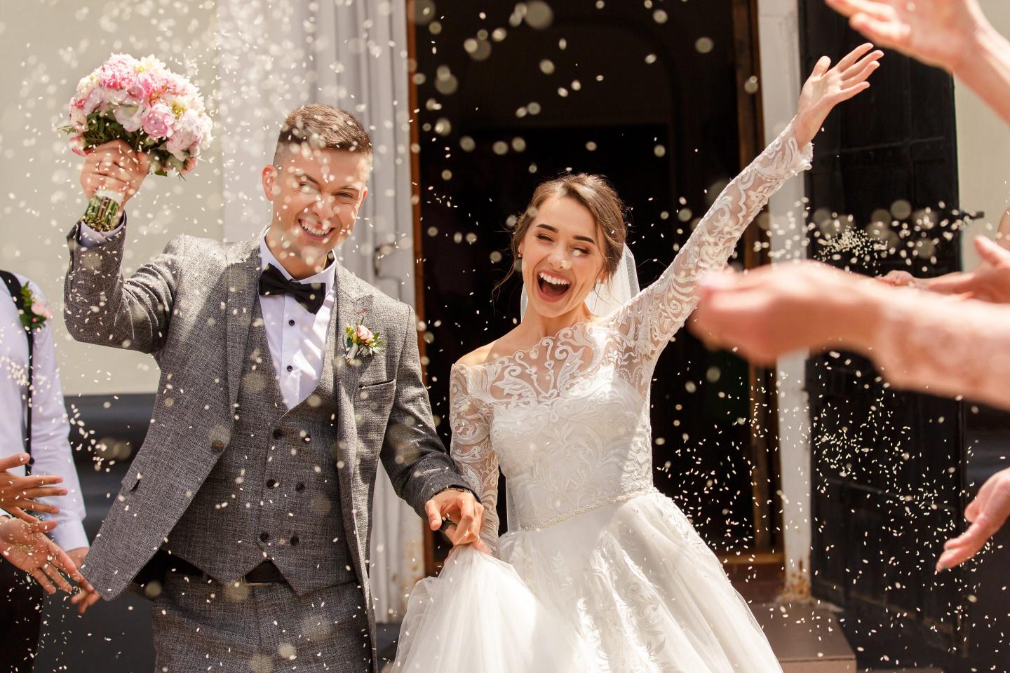 Happy wedding photography of bride and groom at wedding ceremony.