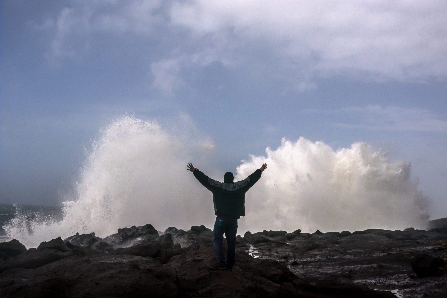 A man reacts to large waves.