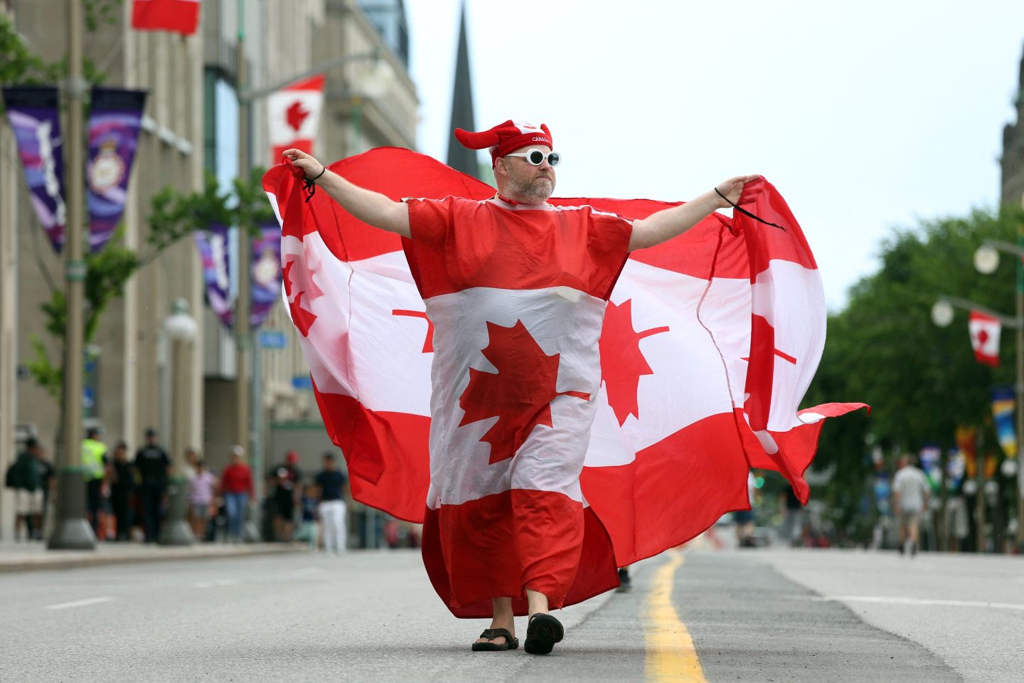 A man wearing Canadian flags marches during Canada Day celebrations on July 1, 2022 in Ottawa, Canada. (Photo by Dave Chan / AFP) (Photo by DAVE CHAN/AFP via Getty Images)