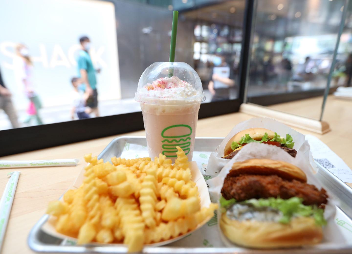 An order of fast food meal (hamburger, chips and soft drink) at a Shake Shack restaurant