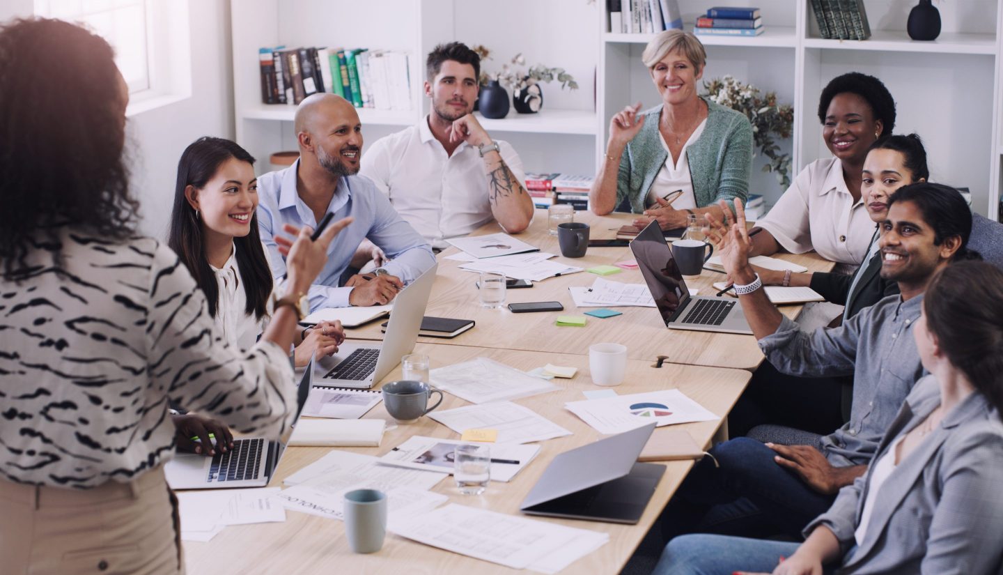 Shot of a group of businesspeople asking questions during a meeting in a modern office