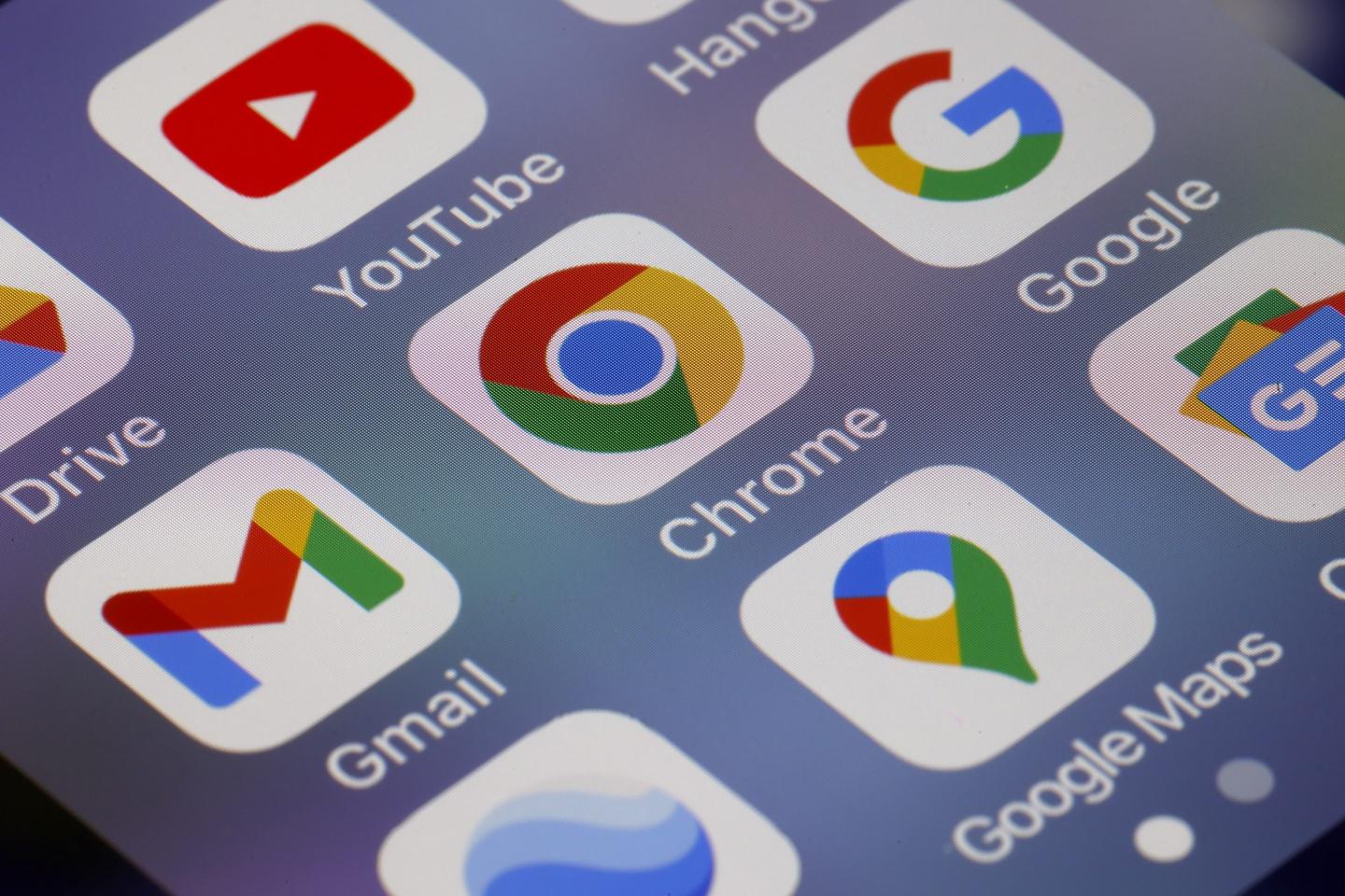Google app icons are displayed on the screen of an iPhone