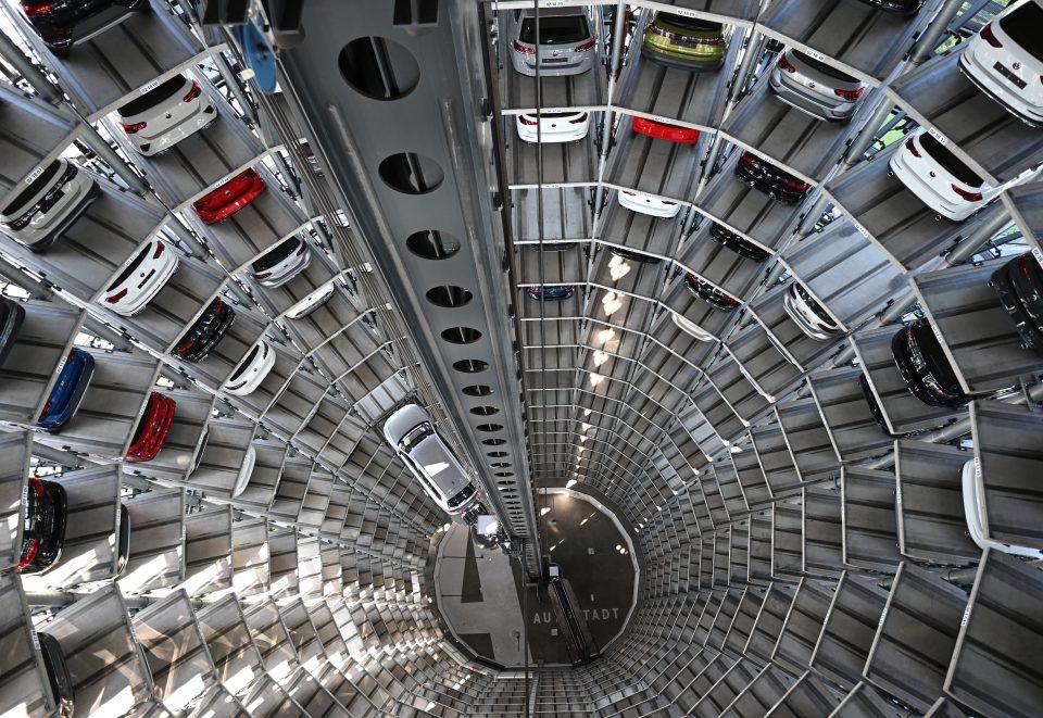 <a href="https://fortune.com/company/volkswagen/" target="_blank">Volkswagen</a> cars stand on elevator platforms