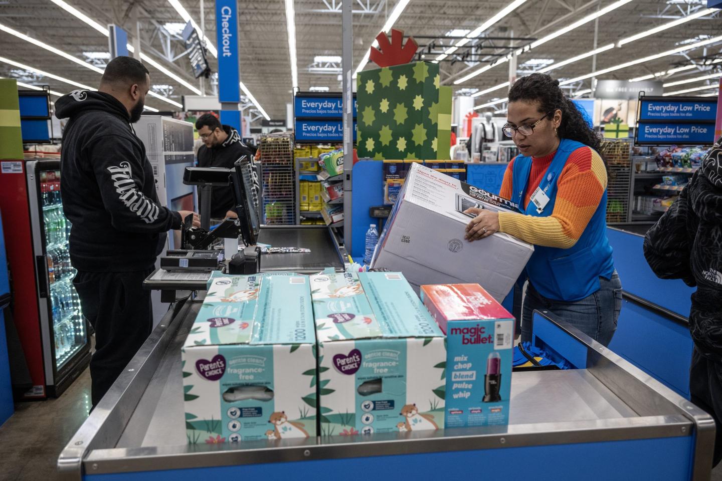 A cashier rings up a Walmart shopper's purchases