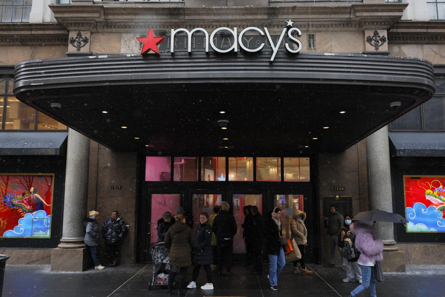 People wait to enter the Macy's store on Herald Square