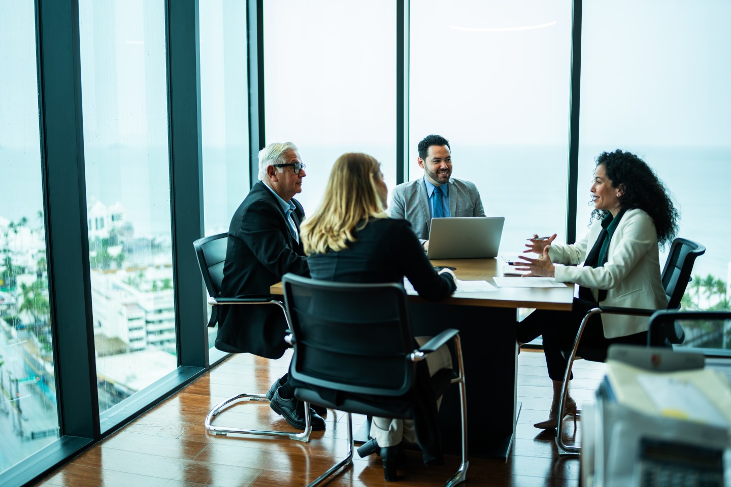 coworkers gathered around a meeting room table
