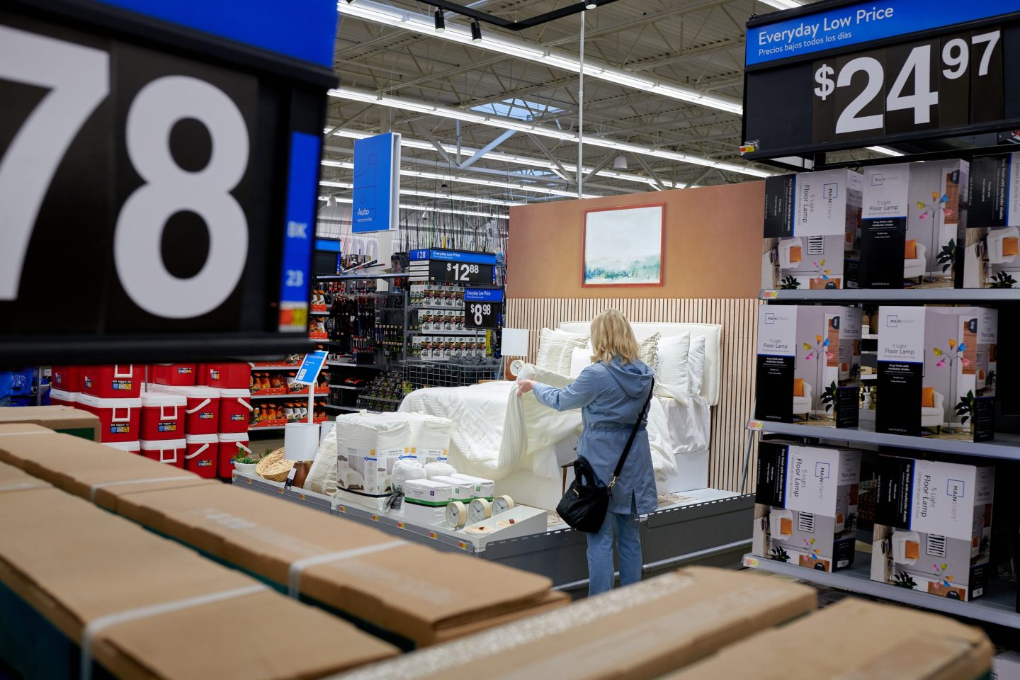 woman looking at bedding in Walmart