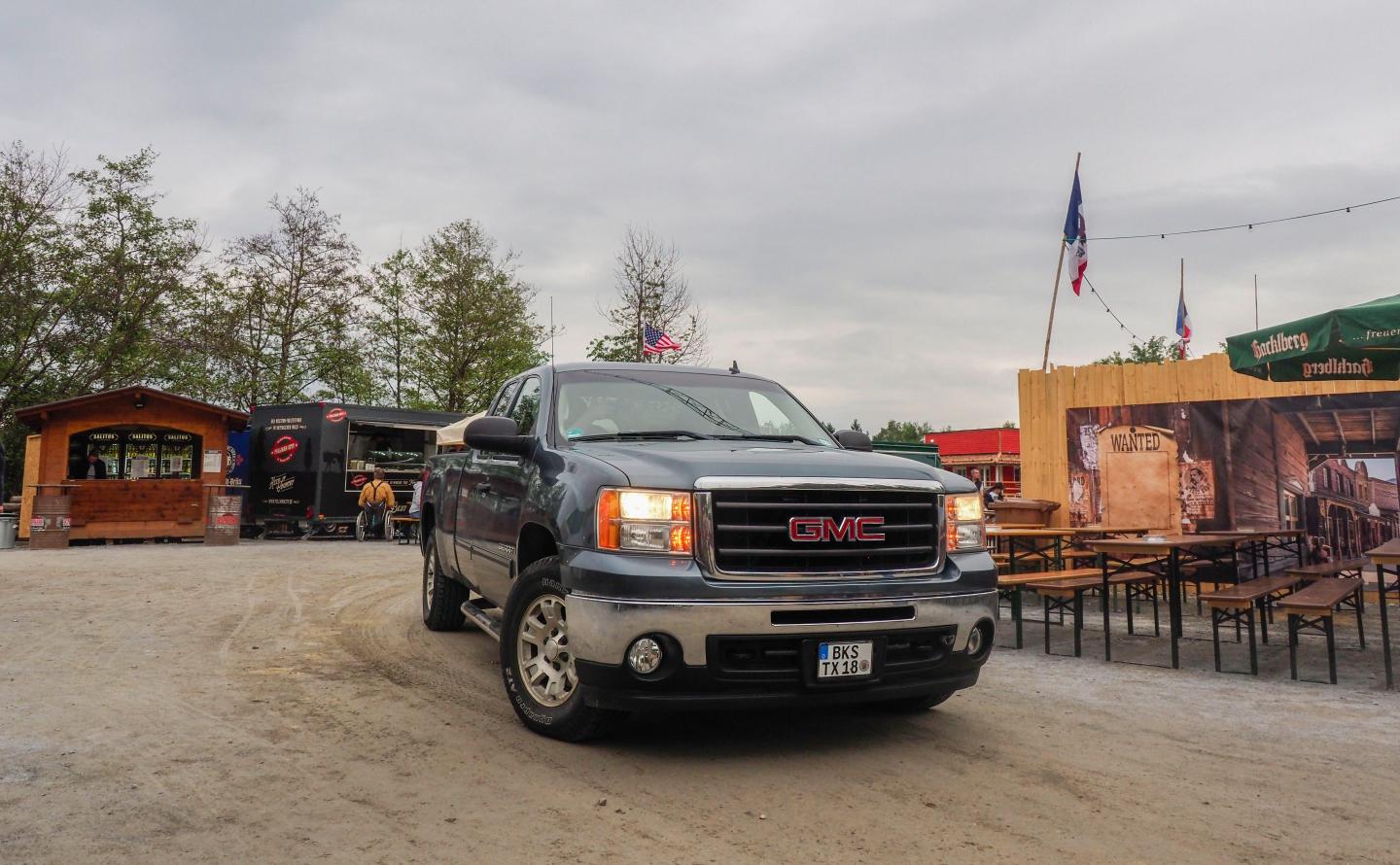 A GMC Sierra pulls out of a parking lot