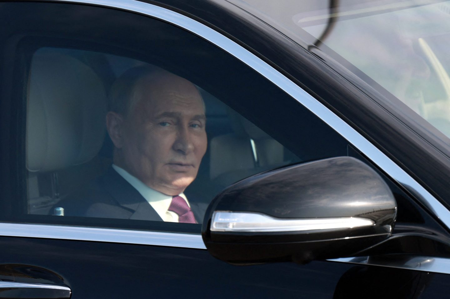 In this pool photograph distributed by Russian state agency Sputnik, Russia's President Vladimir Putin sits in a car driven by Azerbaijan's President Ilham Aliyev (R) following their talks in Baku on August 19, 2024. (Photo by Vyacheslav PROKOFYEV / POOL / AFP) (Photo by VYACHESLAV PROKOFYEV/POOL/AFP via Getty Images)