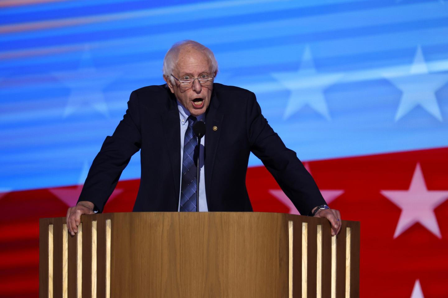 Bernie Sanders speaking at a podium at the DNC.