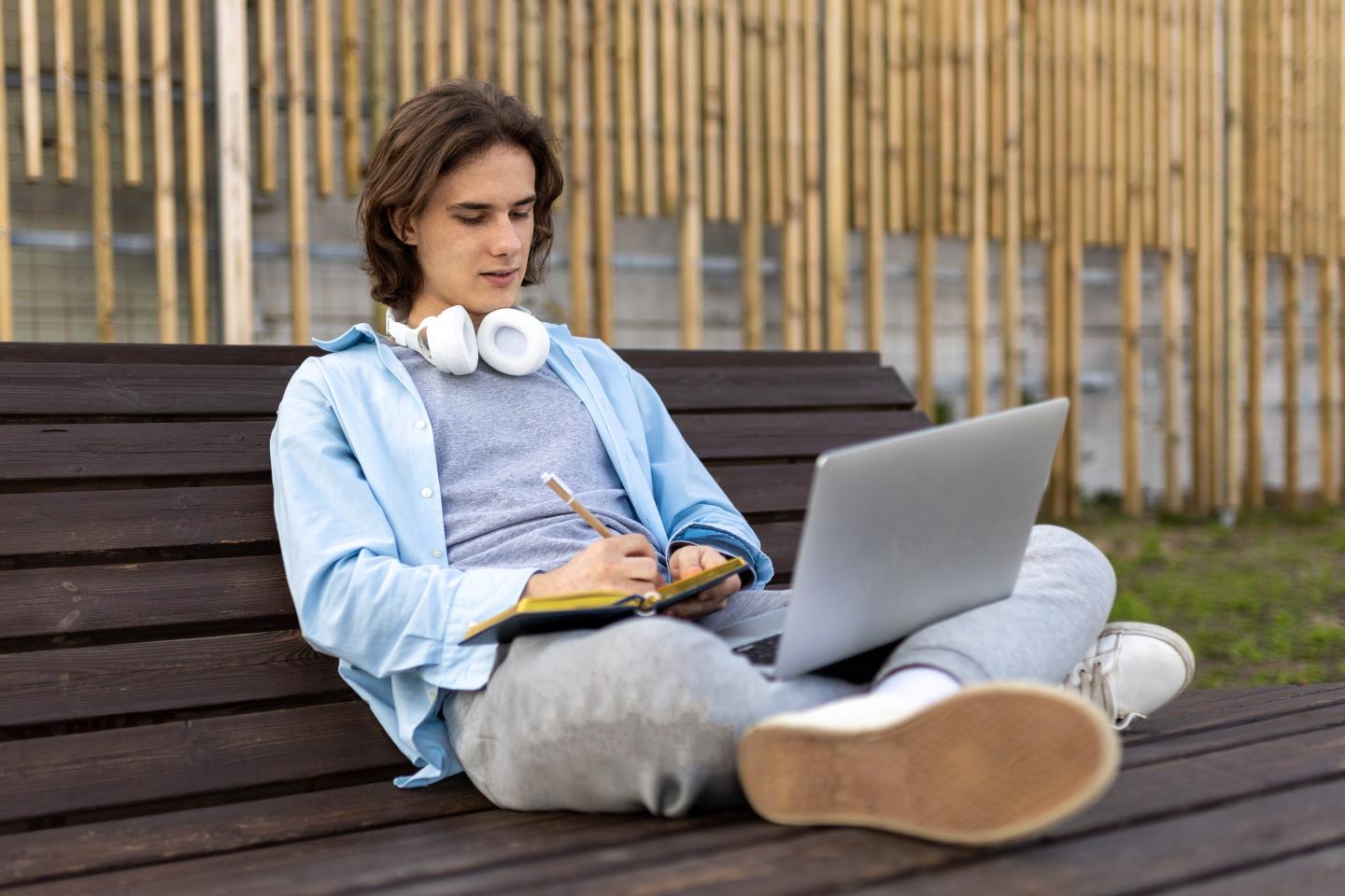 a young man sitting on a bench