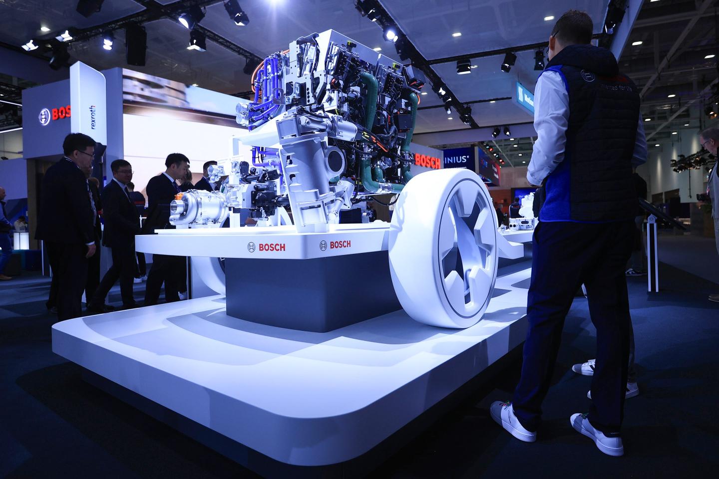 A worker dusts a fuel cell power module at the Robert Bosch GmbH booth at a transportation fair in Germany.