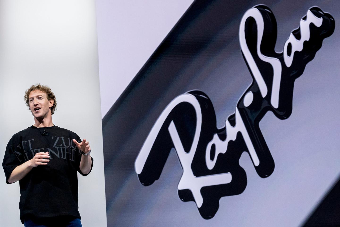 mark zuckerberg speaking on stage and ray ban logo next to it