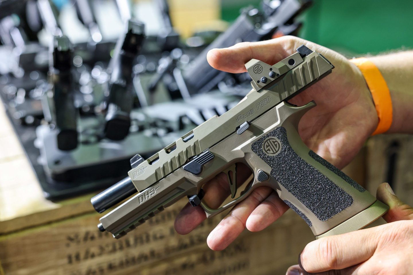 A man shows a SIG Sauer P320 DH3 pistol at the Jagd & Angeln 2024 trade fair, in Leipzig, Germany.