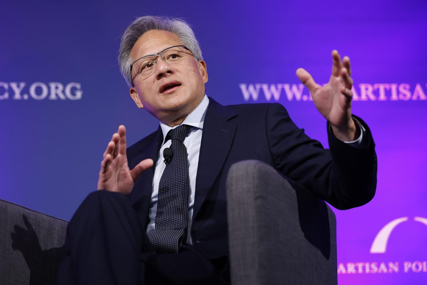 Jensen Huang moves his hands as he speaks on stage.