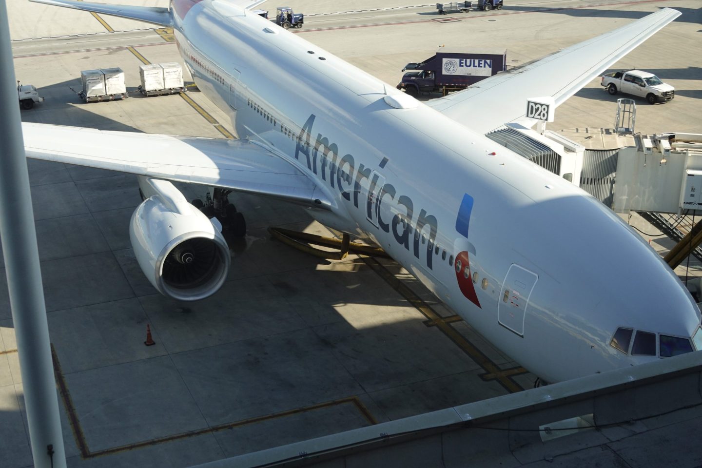 An American Airline plane sits by its gate