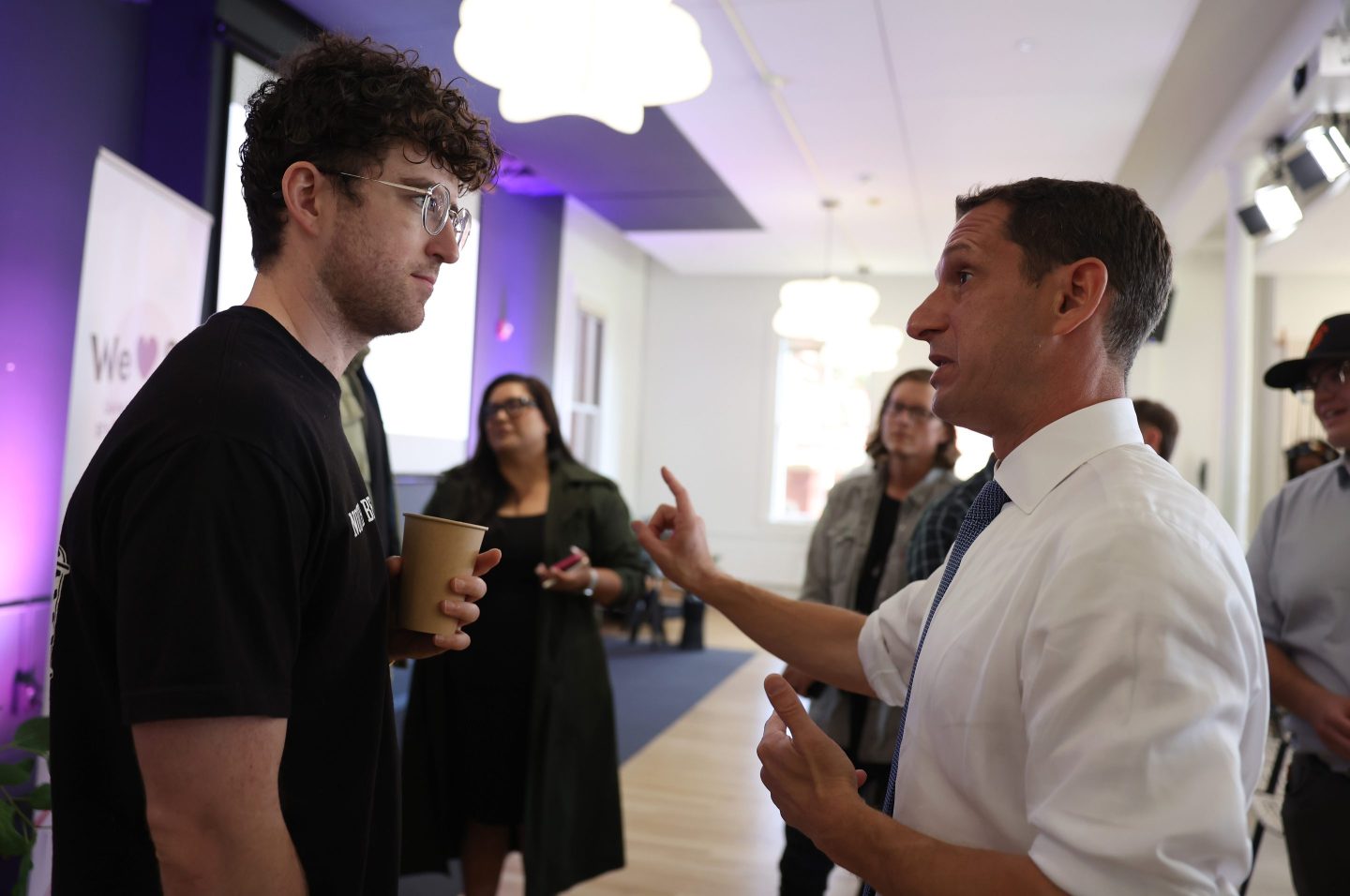 San Francisco mayoral candidate Daniel Lurie (R) talks with a voter during a campaign meet and greet event on October 30, 2024 in San Francisco,